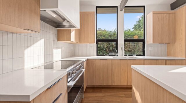 Eleanor Drive kitchen in San Mateo with light wood cabinetry and windows above the sink