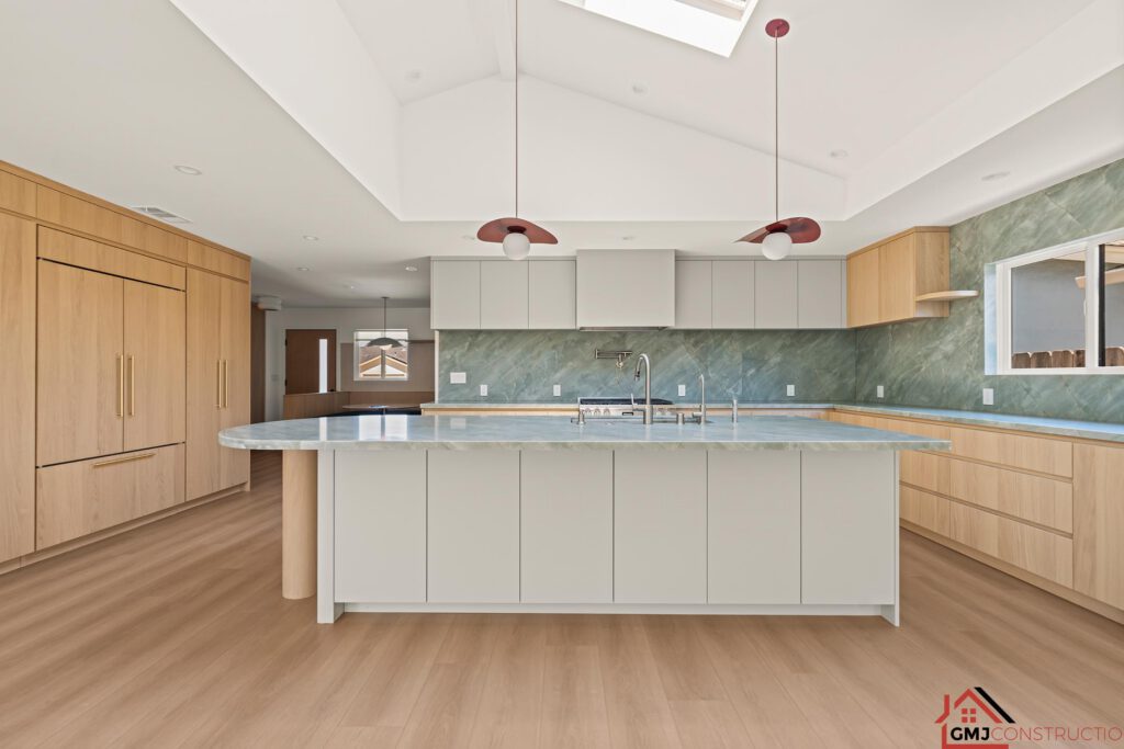 Samson Way kitchen island beneath red-toned pendant lights