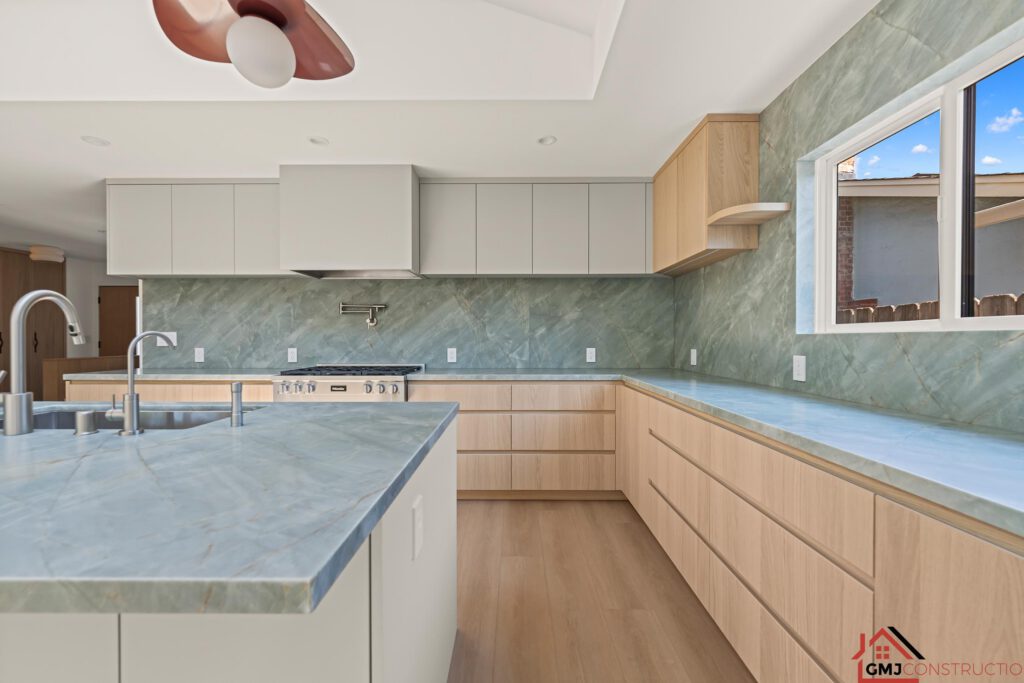 Samson Way kitchen with wood drawers, pale upper cabinets and green-veined surfaces