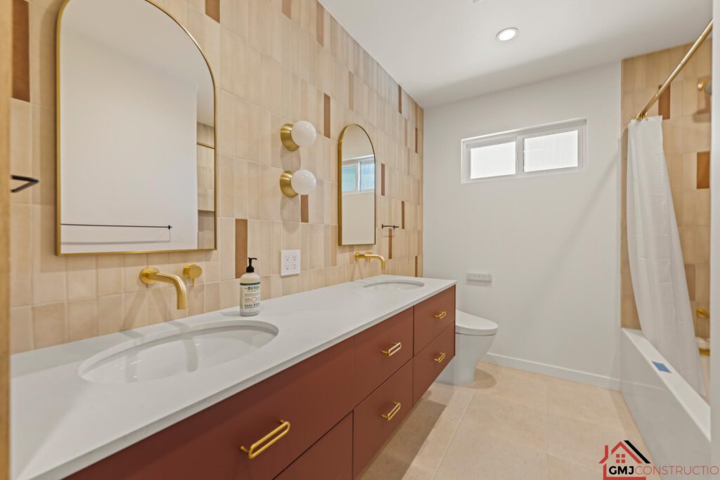 Samson Way bathroom with a rust-toned double vanity and gold-toned wall faucets