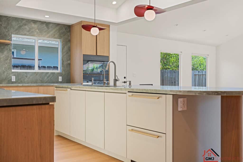 Kitchen island and rounded counter edge with wood cabinetry in the background