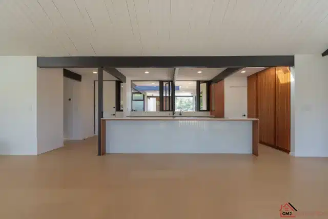 Alison Way Eichler kitchen in Sunnyvale with an island, wood cabinetry and exposed beams