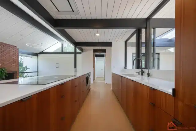 Alison Way kitchen in Sunnyvale with wood cabinet drawers and counters beside a glass wall
