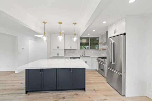 Carlson Cir kitchen in Palo Alto with white cabinetry, a dark island and wood flooring